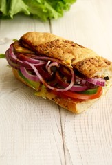 sandwiches with salad, onion, salami, pepperoni, ham, cheese and