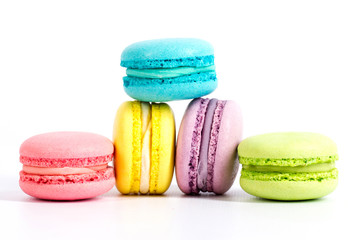 Collection of brightly colored French macarons on white background