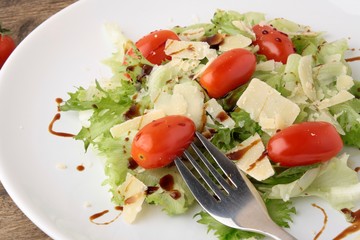 Fresh salad parmesan on a wooden background