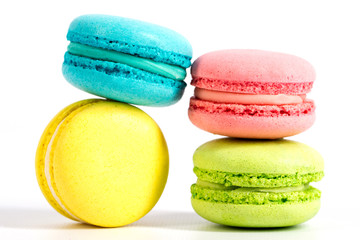 Collection of brightly colored French macarons on white background