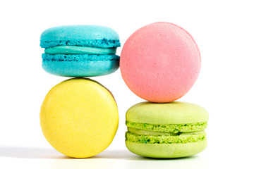 Collection of brightly colored French macarons on white background