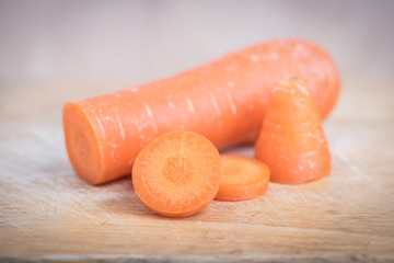 Fresh organic carrots on wooden background
