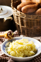 Mashed potatoes  and raw potato in the basket