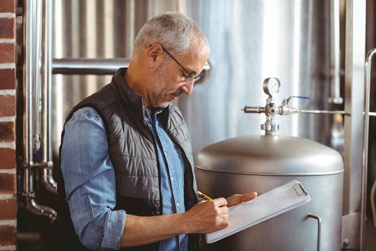 Happy brewer checking his list