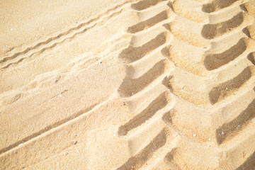 Fototapeta na wymiar wheel tracks on dry sand background