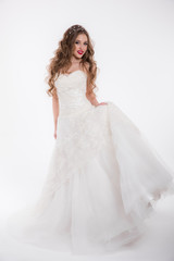 Fototapeta na wymiar Beautiful girl in a wedding dress isolated on white
