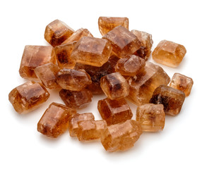 Brown caramelized lump cane sugar cube isolated on white backgro