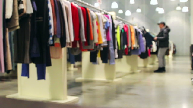 buyers choose the clothes in the store. Blurs