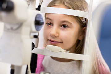 Girl look at ophthalmoscope