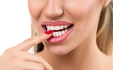 Naklejka premium Sexy woman mouth with finger between tooth