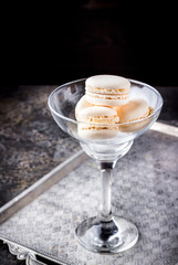 Macaroons in a glass on a high leg.