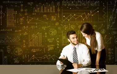 Business couple with diagram background