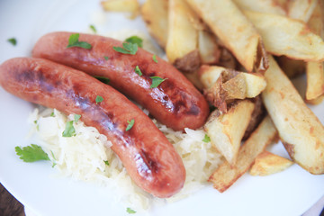 Sausages on sauerkraut with fries 