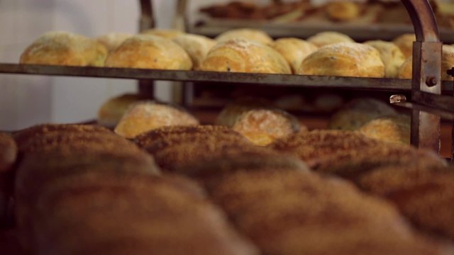 Baking bread. Bakery. Shelves with fresh baked crispy bread. Farinaceous foods