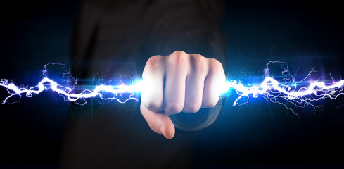 Business man holding electricity light bolt in his hands - obrazy, fototapety, plakaty