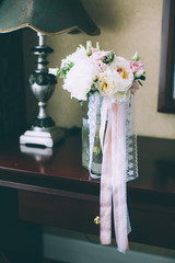 Colorful wedding bouquet in vase in bridal suite