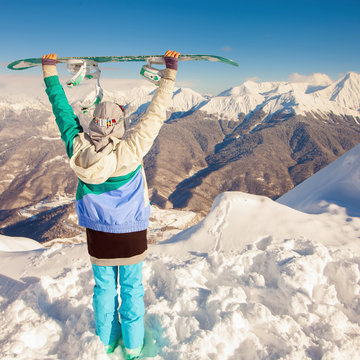 Snowboard. Sport woman in snowy mountains