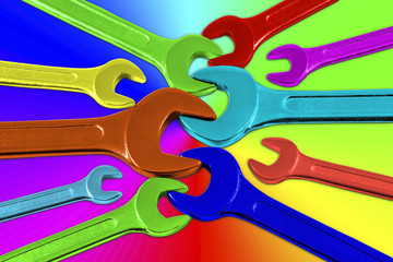 Set of multicolored wrenches on a colored background.