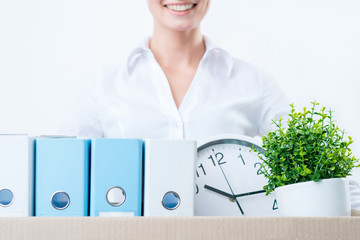 Pleasant woman holding box with things 