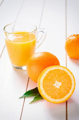 Orange Juice and orange fruit on white table