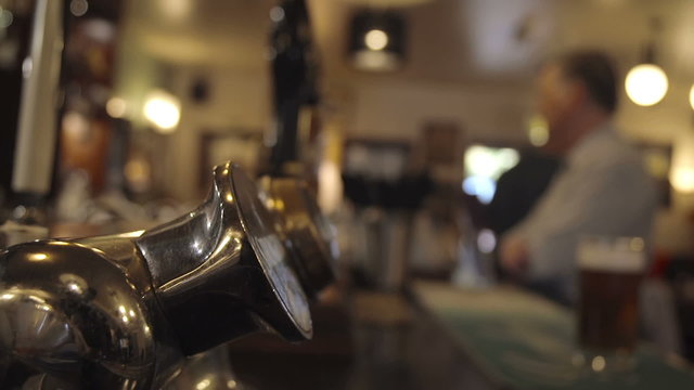Bartender Pulling A Pint In A British Pub