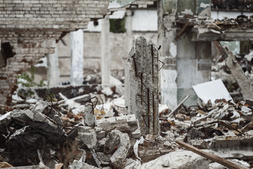 A closeup image of a garbage dump with ruined building after disaster