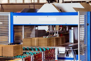 Closeup image of cardboard boxes on conveyor belt