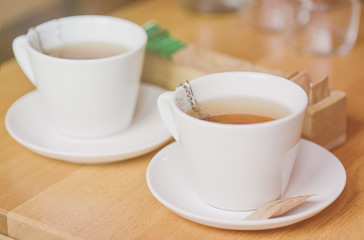 Two cups of tea on a wooden table