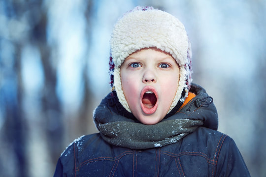 Closeup Winter Portrait Of Young Shouting Boy In Hat, Scarf