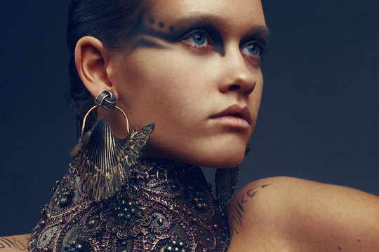 Portrait of a beautiful woman with creative airbrushed makeup and designer accessories,close up 
