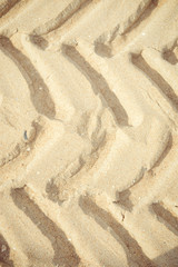 Tyre traces on dry sand background for articles about traveling