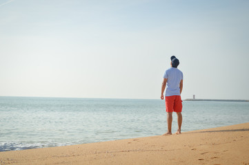 Man standing with the ocean in the background.