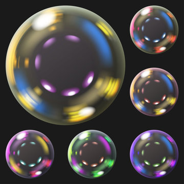 Set of multicolored transparent soap bubbles with glares. Transparency only in vector format