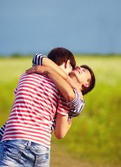 young male couple embracing outdoors