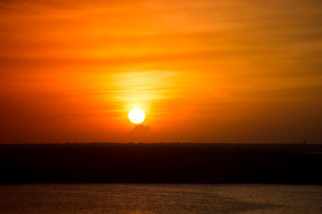 Beautiful yellow sunset with orange sky and clouds