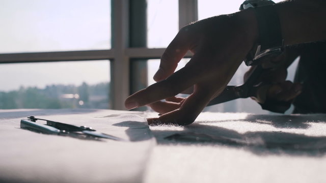 Close up female hands cut cloth with scissors, dolly, slow motion, dolly shot