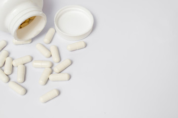Pills from bottle on the white