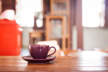 Purple coffee cup on wooden table