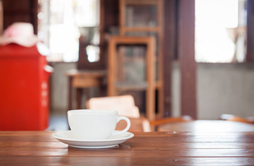 Fototapeta na wymiar White coffee cup on wooden table