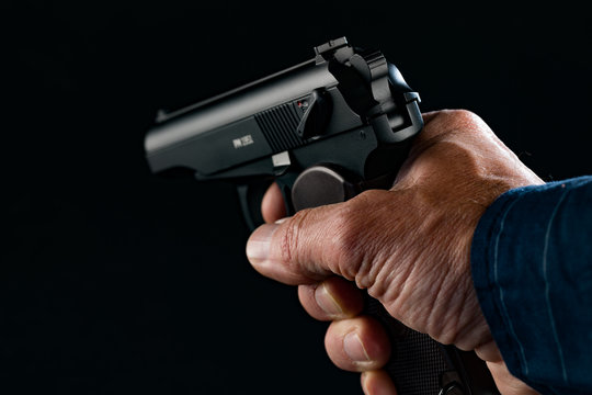 PM makarov Gun in man hand on black background