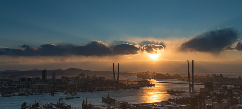 Vladivostok cityscape, dramatic sunset sky.