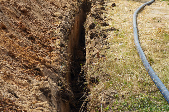 Deep narrow ditch for water pipe