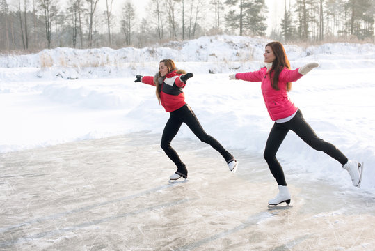 Coach of figure skating with apprentice practise at the frozen lake in the winter