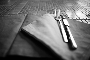 cutlery on the table in a restaurant table setting, knife, fork, spoon, interior