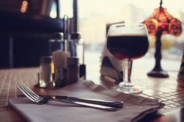 glass of dark beer in a pub