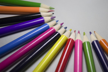 Colored pencils in a semicircle with space for text