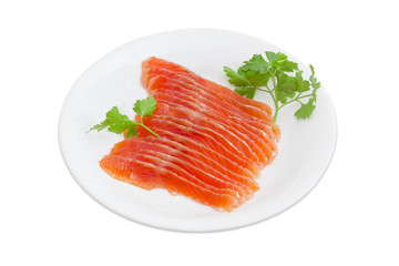 Sliced fillet of salted rainbow trout on a white dish