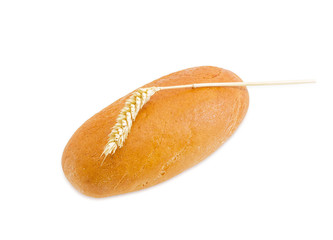 Wheat bread and wheat spike on a light background