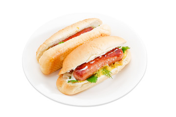 Two hot dog on a white dish