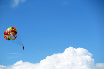 Parasailing girl against a blue sky